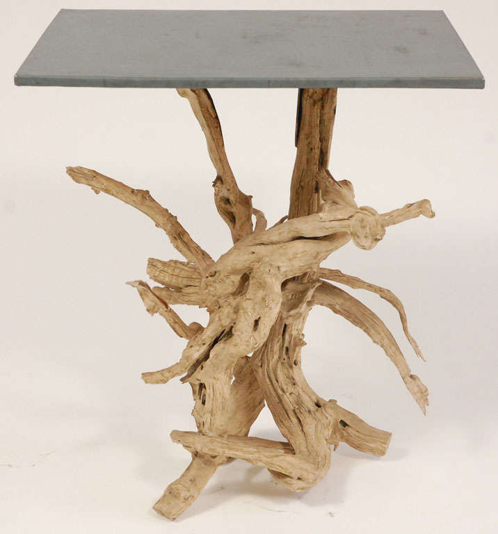 This nice side table has a metal top supported by an inter-twined driftwood base. The table is thought to be American and from the 1930's.  It will make a nice feature where a natural feeling is desired. 
