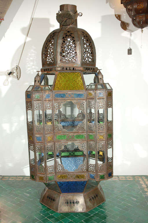 Oversized Moroccan candle glass lantern from Marrakesh, clear and multicolored glass adorned with filigree Moorish designs. High end traditional Moroccan hurricane candle lantern handcrafted in Morocco by skilled artisans. Clear glass bottom, one