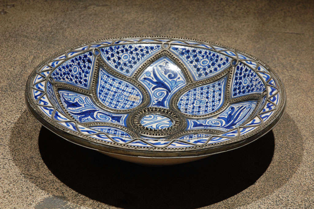 Handcrafted Moroccan ceramic plate, handmade by artisans from Fez.
Blue de Fez with white designs with nickel silver filigree designs.

Mosaik provides Antiques, Art Deco, Moorish Style, Spanish, African, Islamic Art, Arabian, Middle Eastern,