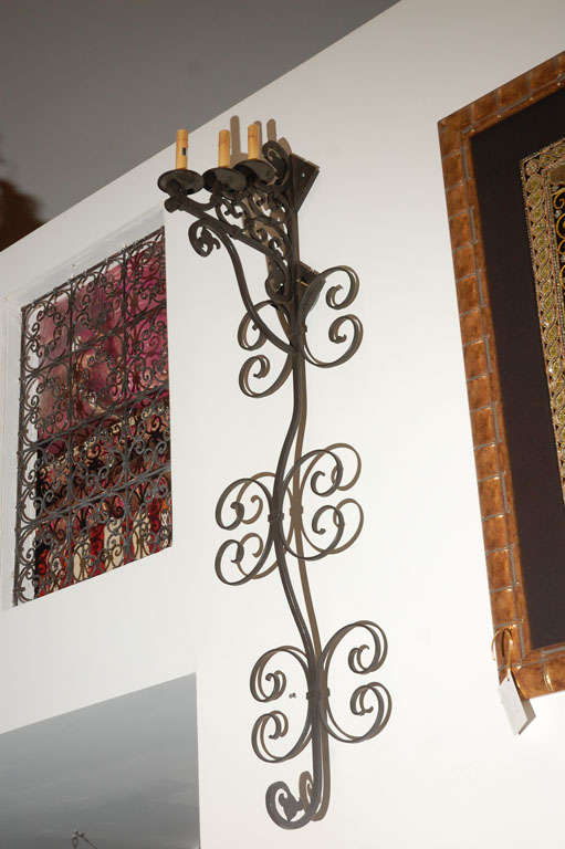 Set of three very large Moorish Spanish style wrought iron wall sconces with three candle lights.
Iron is black finish.
Wired for electricity ready to install.


  