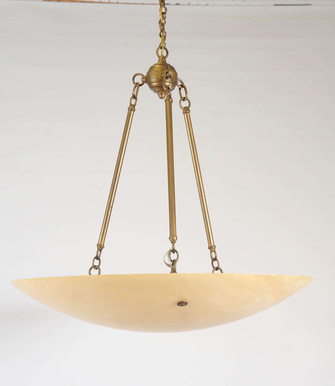 A large high quality handmade neoclassical style alabaster hanging fixture with antiqued metal elements.  OAH to the top of the ring before chain is 30