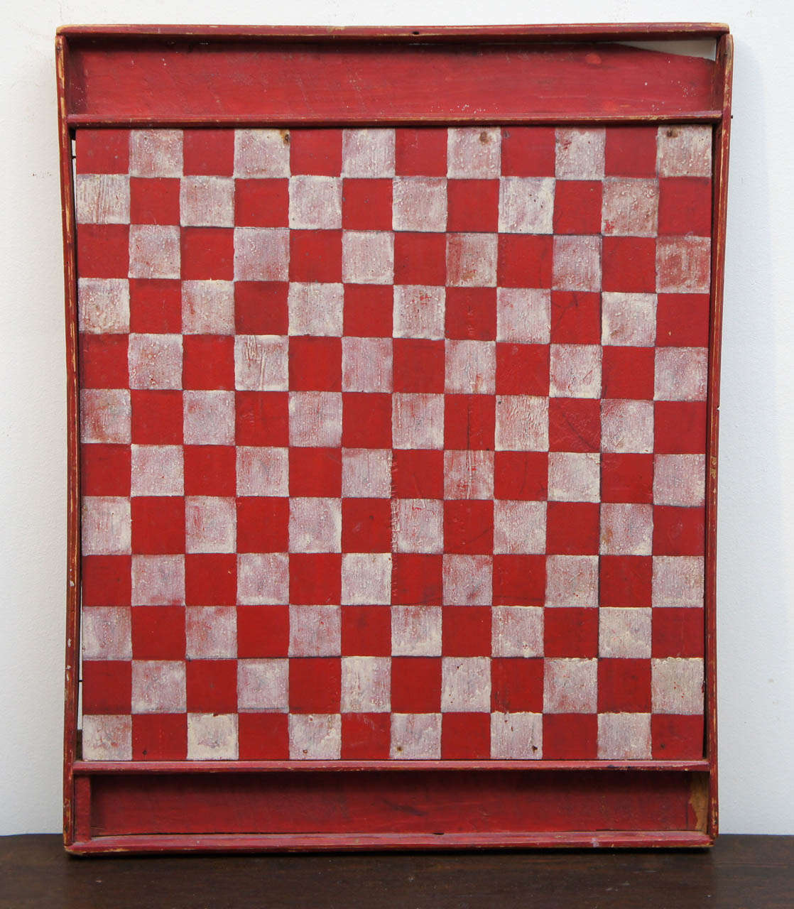 Draughts is the Canadian version of checkers and has more squares than the American game. The coloration is terrific and this piece has a slot on each end to hold the pieces. It is nicely worn and added to a collection or hanging by itself would be