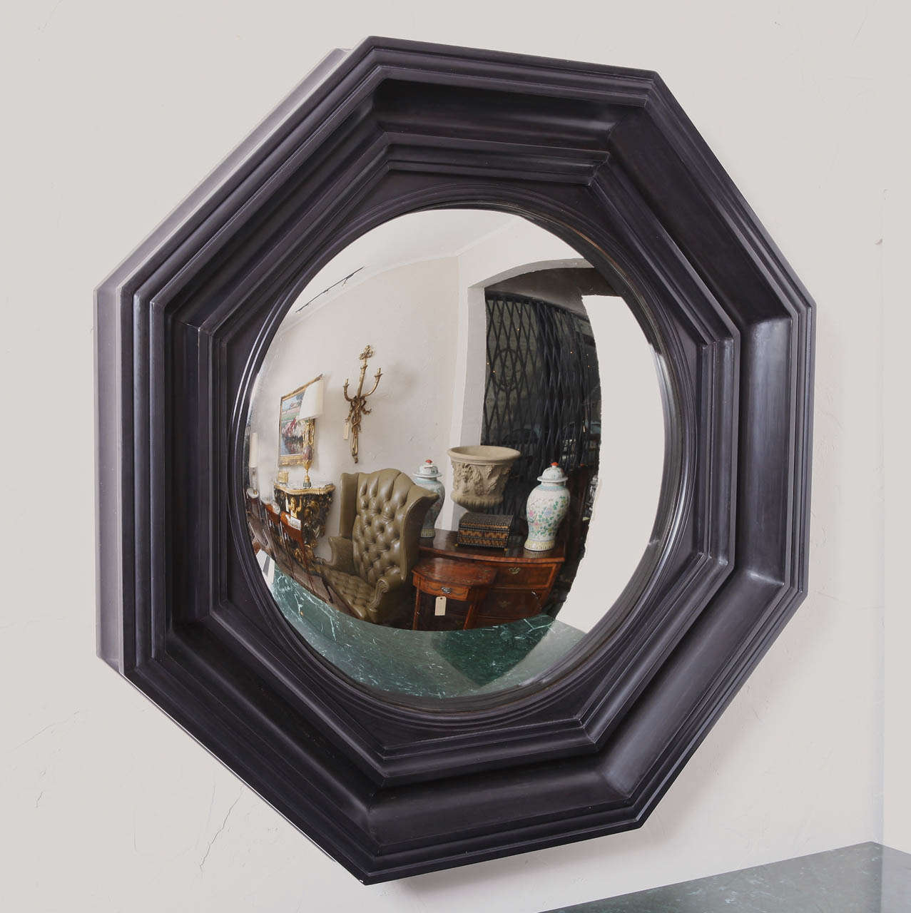Regency style carved wood and ebonized convex mirror