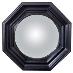 Regency style carved wood and ebonized convex mirror