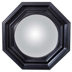 Regency style carved wood and ebonized convex mirror