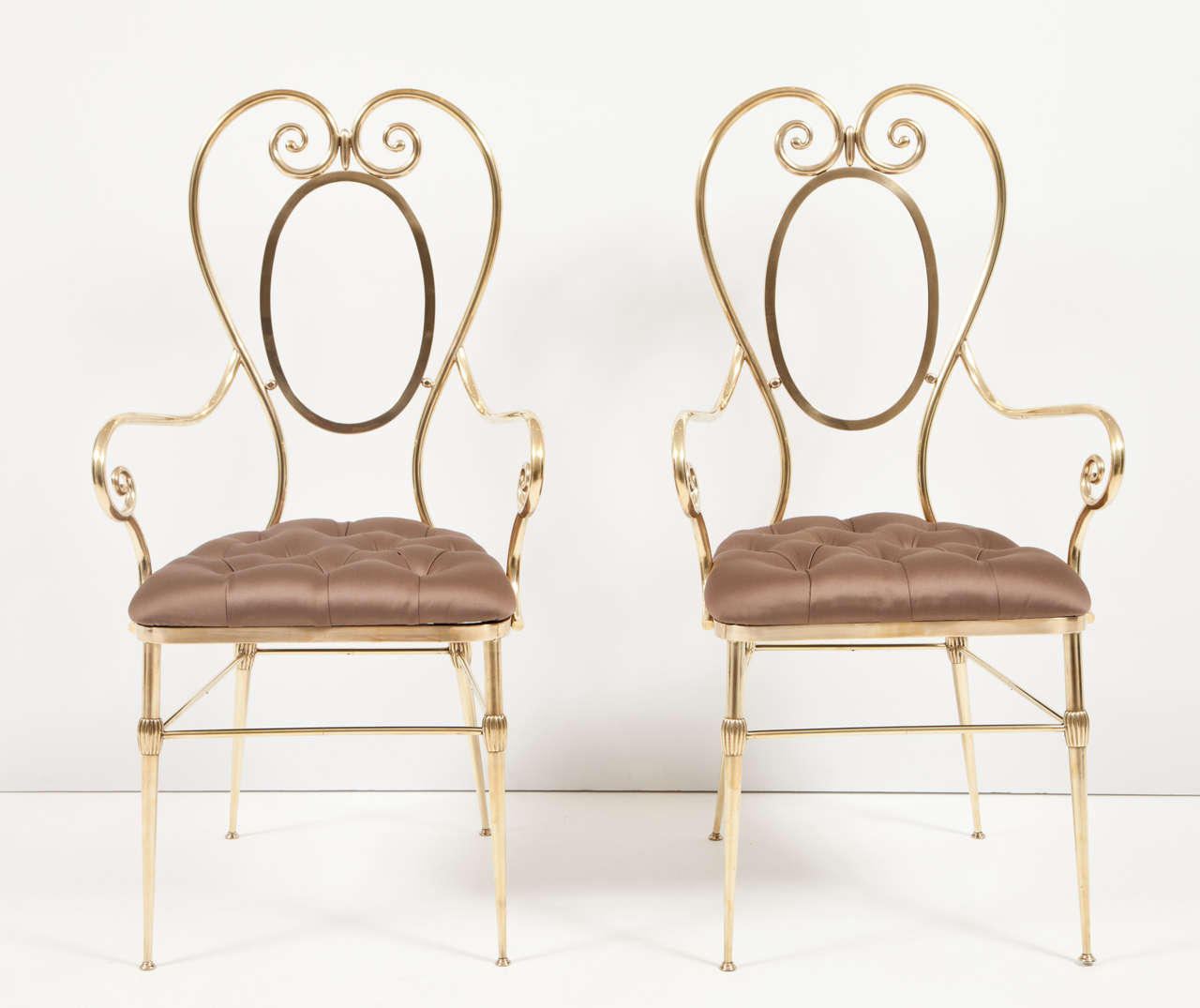 Decorative pair of midcentury, brass side chairs, Italy, circa 1950. Upholstery in silk fabric, diamond tufting. Measures: seat Height is 18 inches.