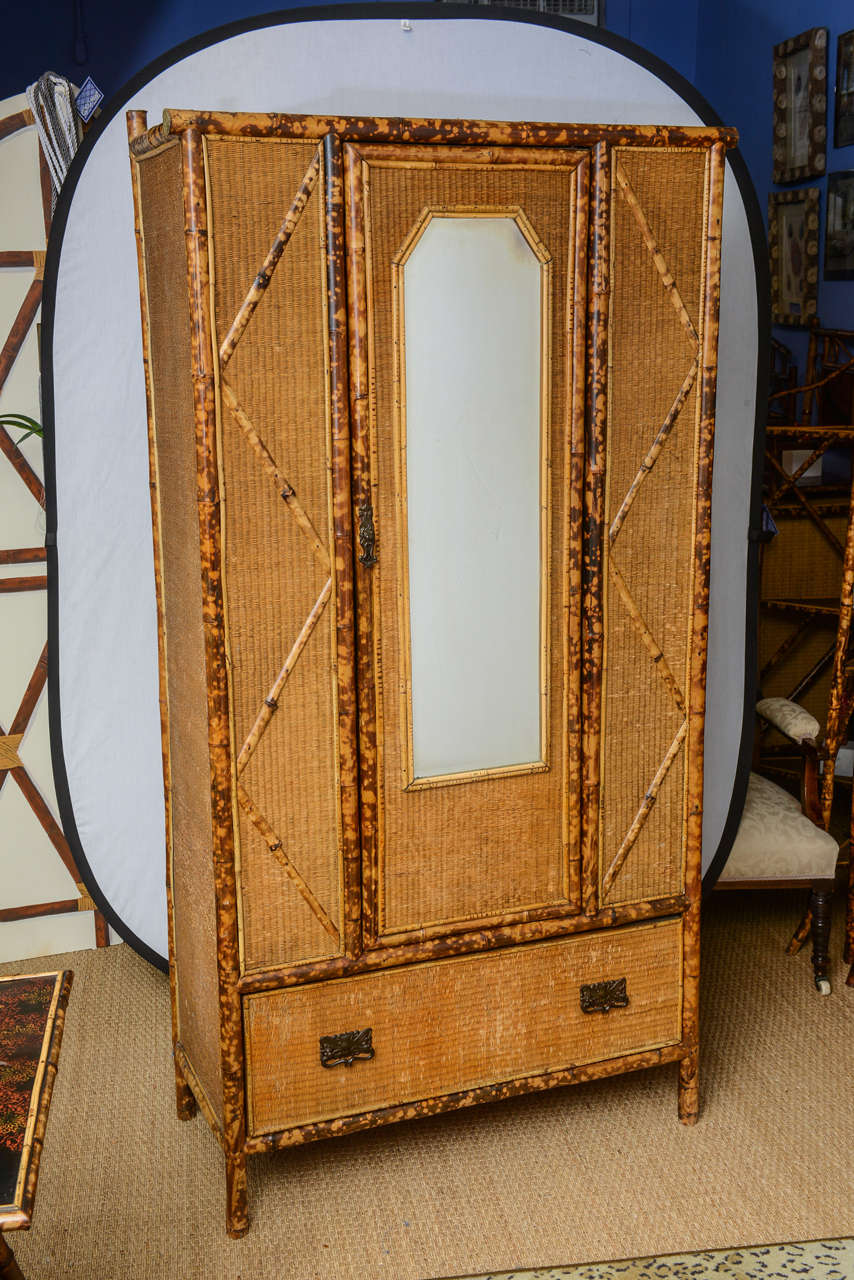 English bamboo and cane armoire with shelves.