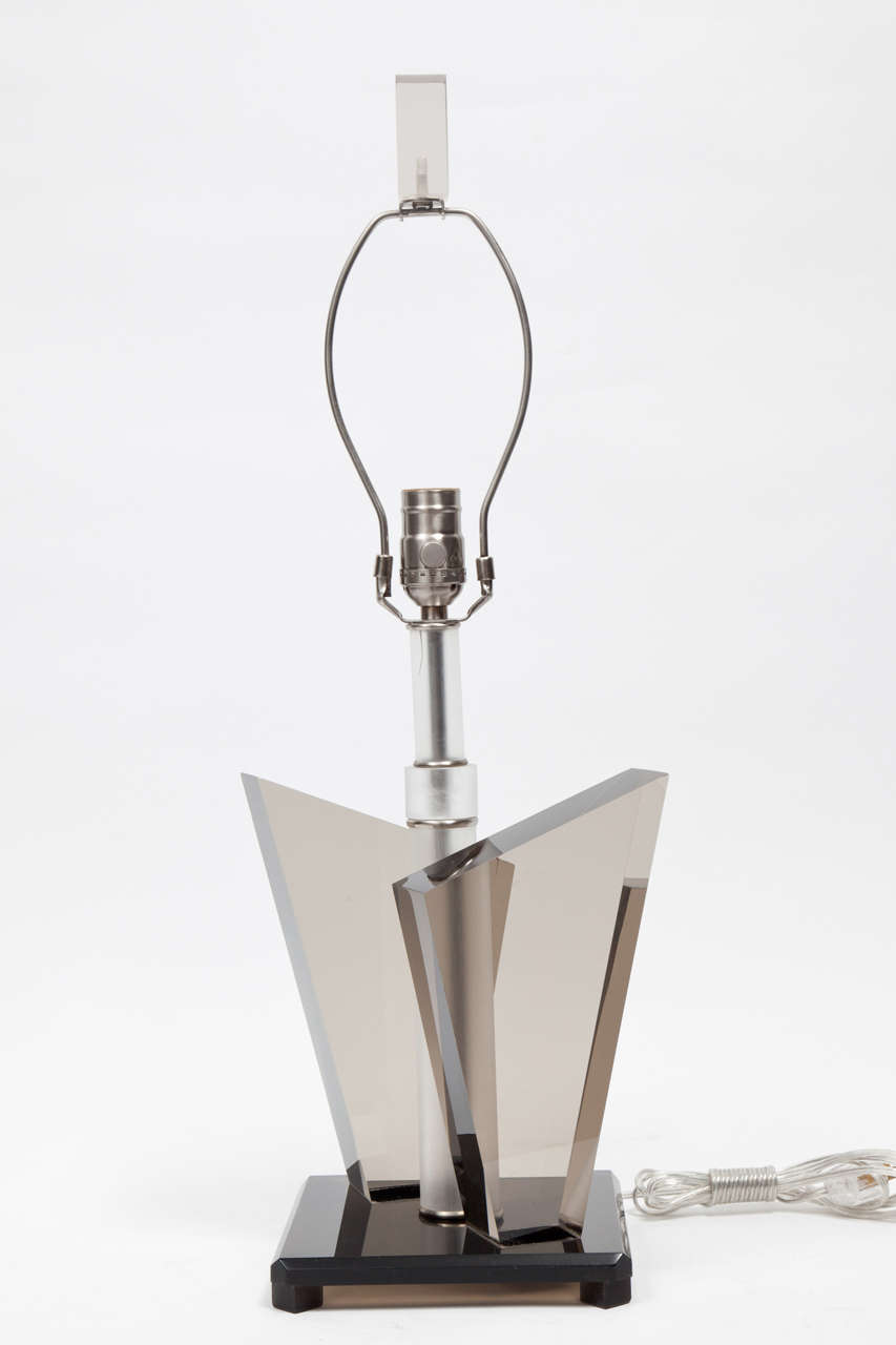 Chic pair of smoked angular Lucite lamps on a smoked Lucite base featuring a frosted center stem and matching rectangular finial.