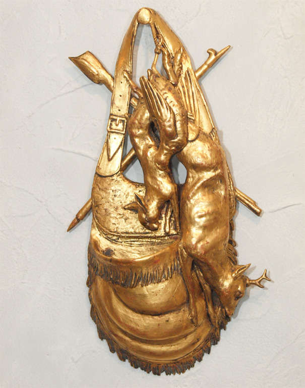Pair of Black Forest carved trompe l'oeil gilded trophees.