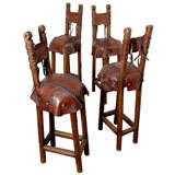 4 diminutive hand carved, rough cut walnut and leather stools
