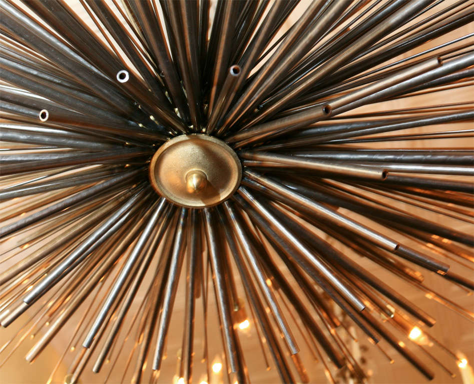 A bespoke original sculptured chandelier by Lou Blass called Supernova, executed in steel with bronze accents, with 24 lights. It weighs aprox. 42 pounds.

Please go to our store front for more versions of this and other fixtures, that we