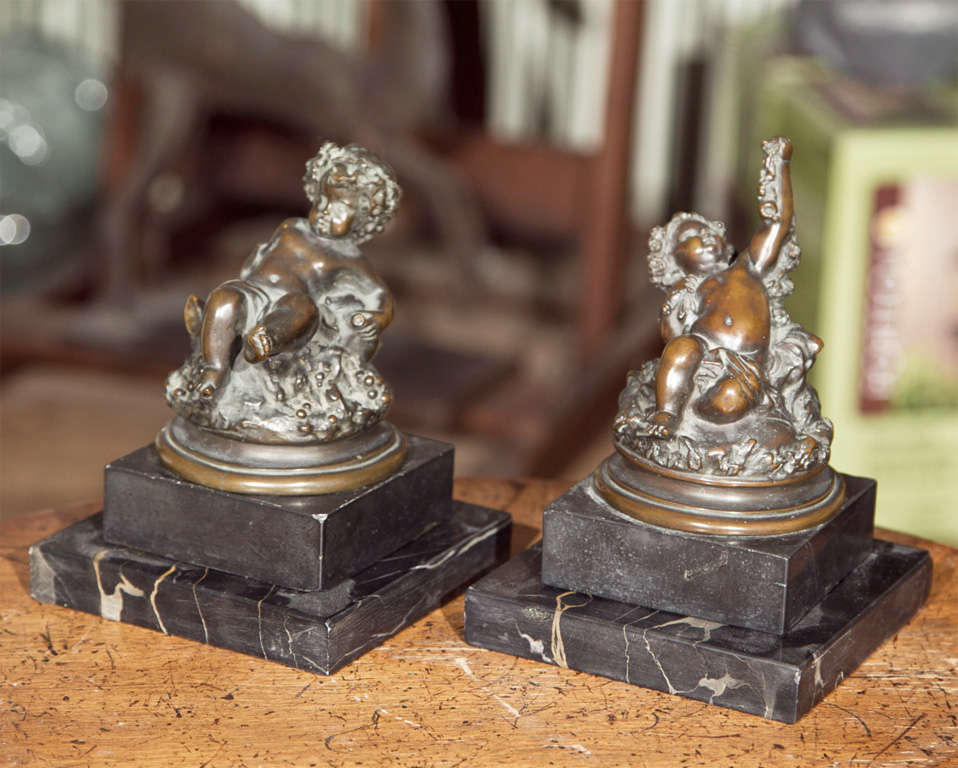 TWO DIFFERENT CAST SMALL CHERUP BRONZE STATUES, THEY ARE A PAIR.ONE HAS ARM RAISED AND OTHER HAS LEG RAISED. TWO SLABS OF MARBLE BASES. CUSTOMER AQUIRED THEM IN 1930 IN ROME ITALY BUT NISINI HAS BEEN DOING CASTING SINCE 1910. SUPURB CASTING.