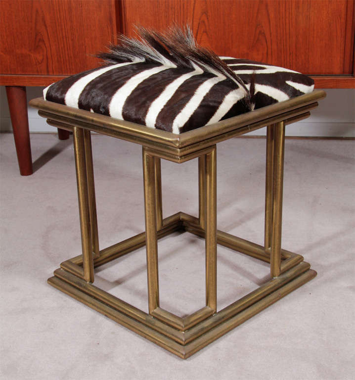 Stool with tubular brass base and zebra skin upholstery.<br />
<br />
Reduced From: $2100