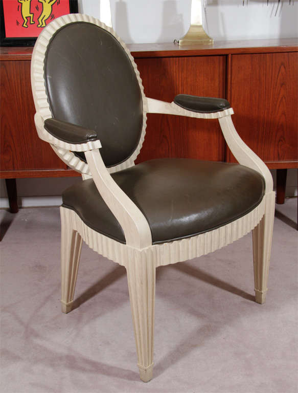White Donghia occasional chairs with charcoal gray leather upholstery and fluted detailing