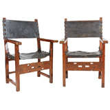 Pair of Spanish Colonial Leather and Carved Oak Open Arm Chairs