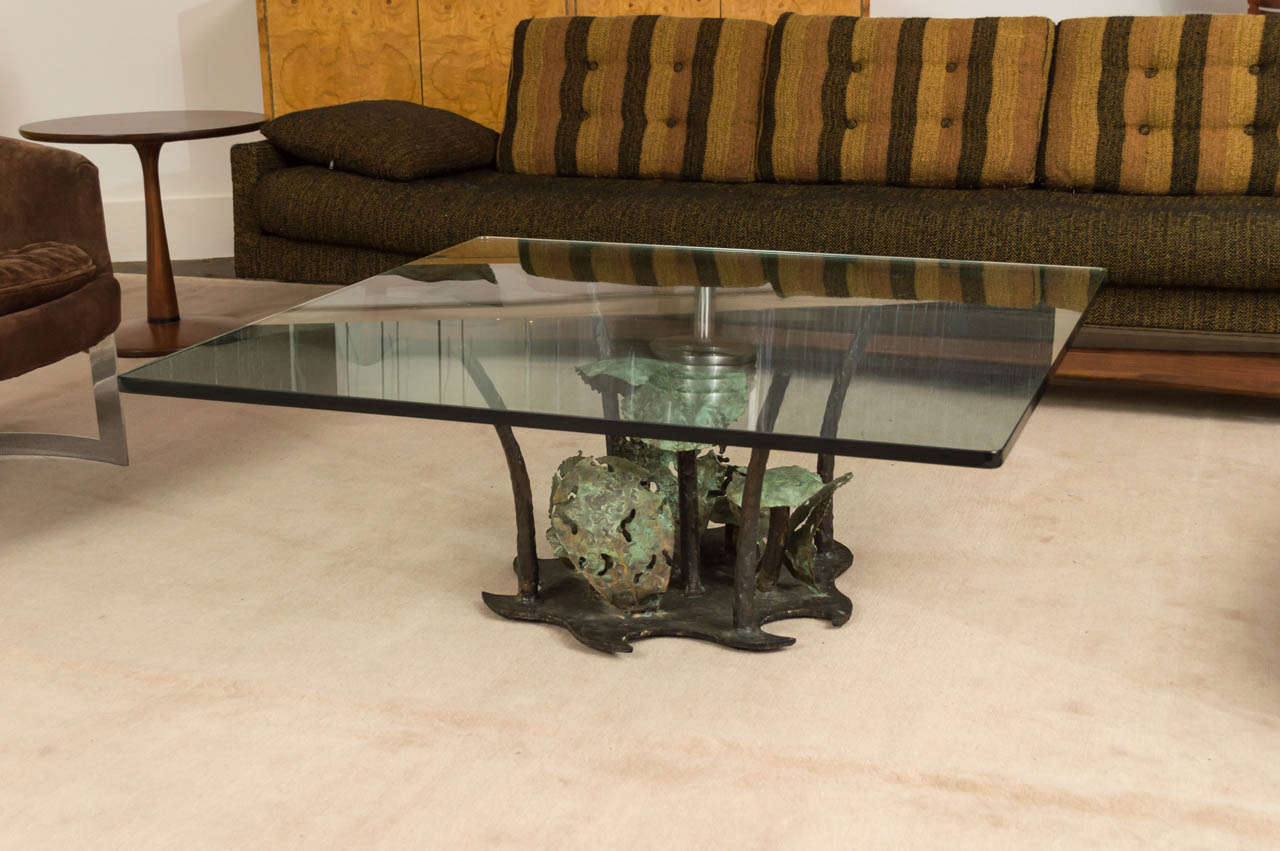 A brutalist woodland coffee table by Silas Seandel. enameled bronze mushrooms and bronze sprouts support glass square top.
