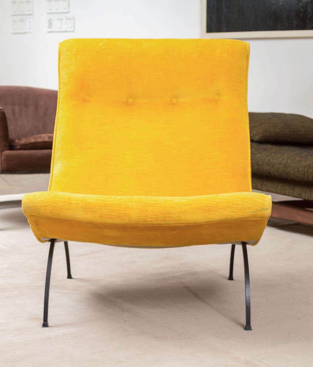 A scoop chair by Milo Baughman in lemon yellow velveteen upholstery. Curved steel legs.
