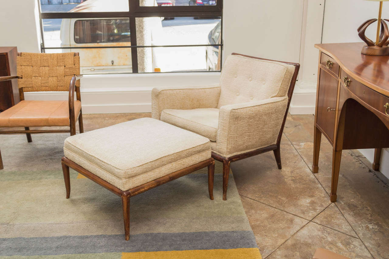 An Arm Chair and Ottoman T. H. Robsjohn-Gibbings for Widdicomb. Elegant walnut feet set off this chair.