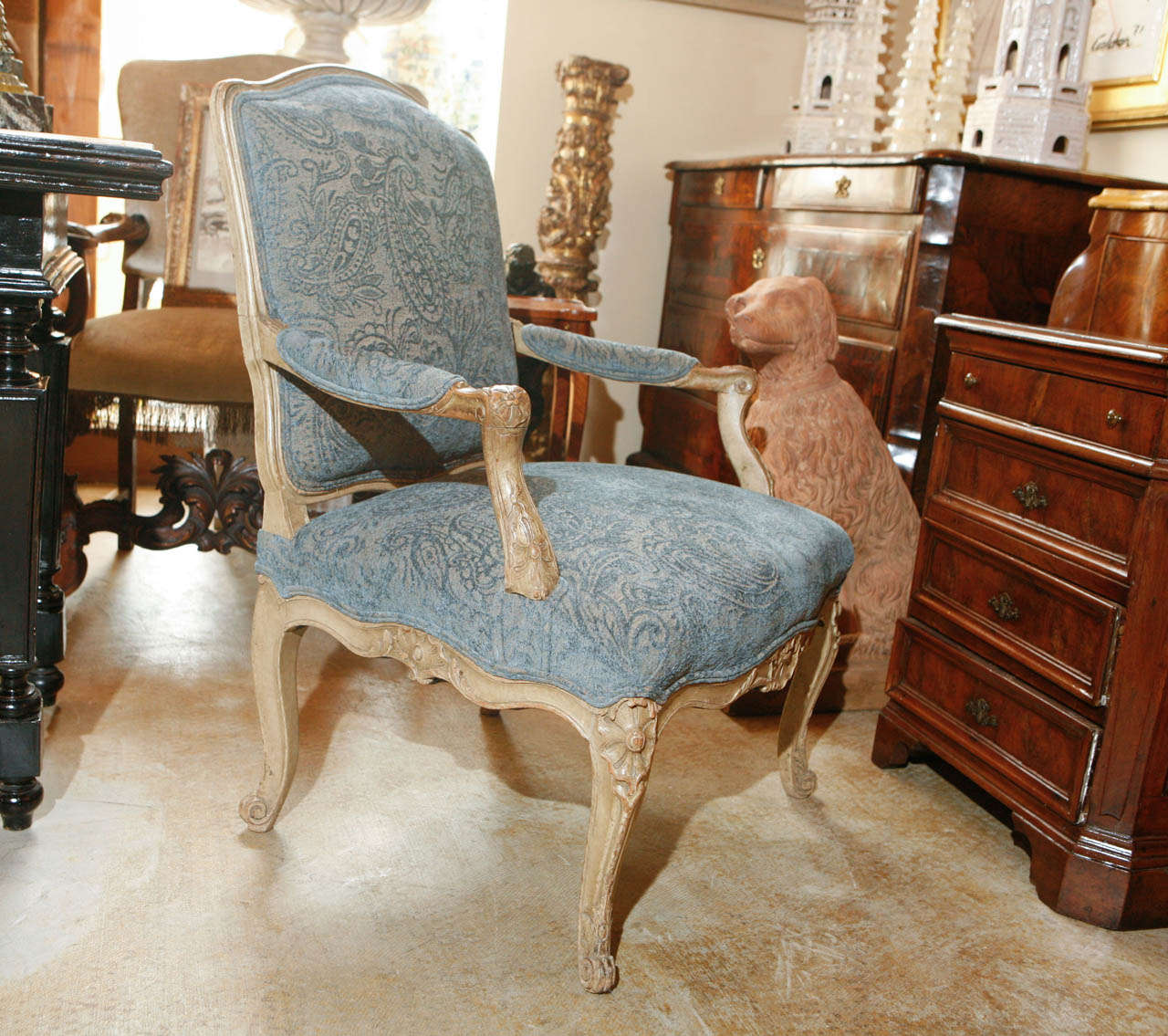Pair of hand-carved, French fauteuils with scrolling aprons and covered in paisley, indigo, velvet fabric.