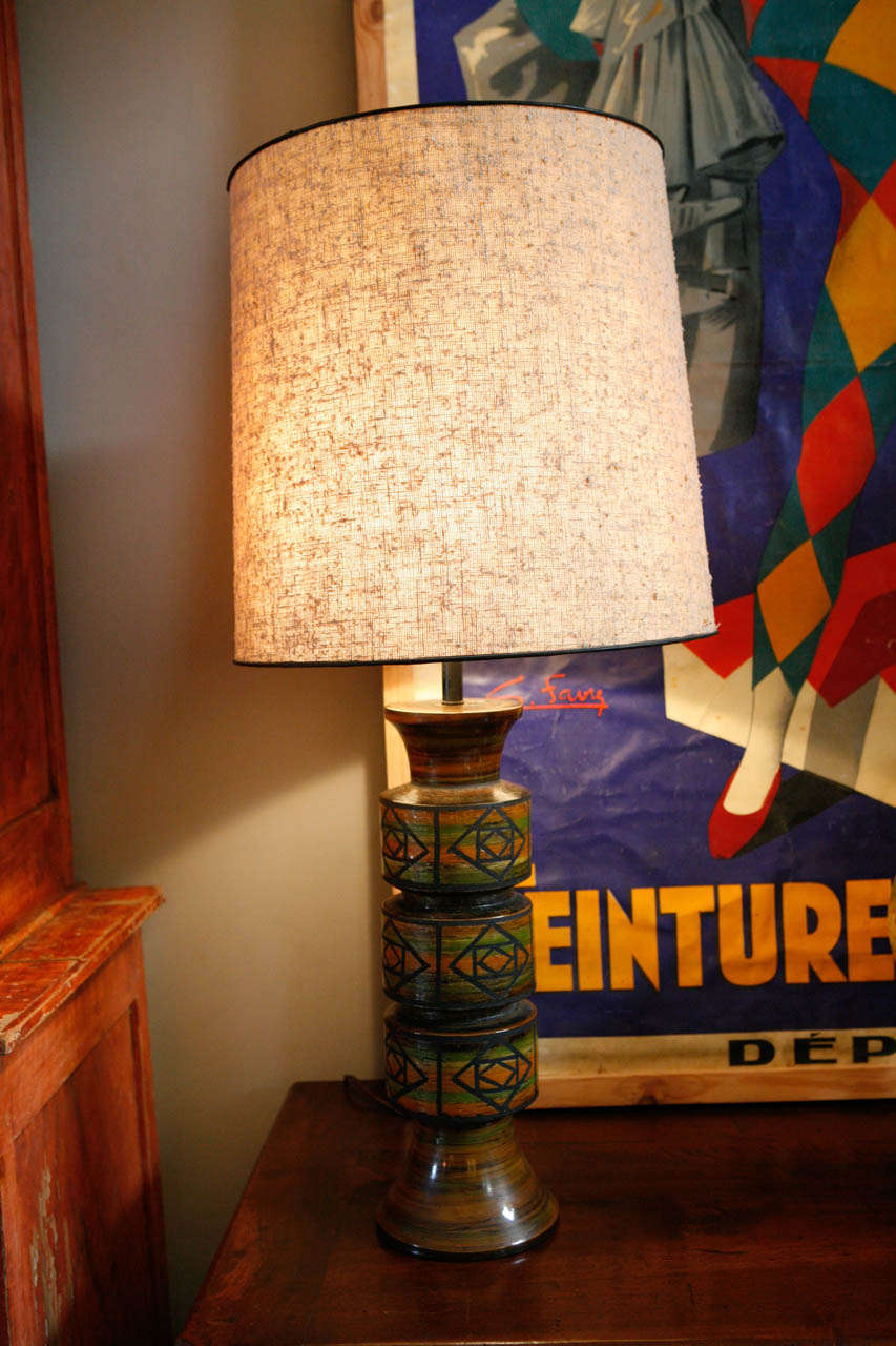 A pair of Mid-Century pottery lamps with colored glaze and incised abstract pattern. With custom shades.