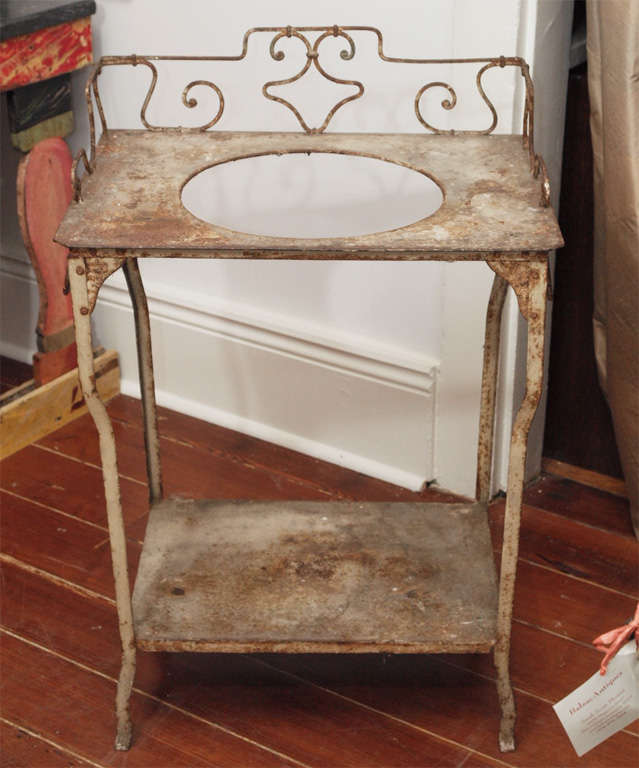 Charming painted iron sink base with a lower shelf, towel bars, 