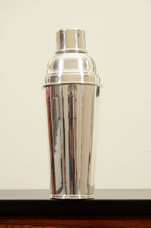 Cartier sterling silver cocktail shaker with strainer. Modern and clean design free of embellishments or engraving. Signed Cartier.