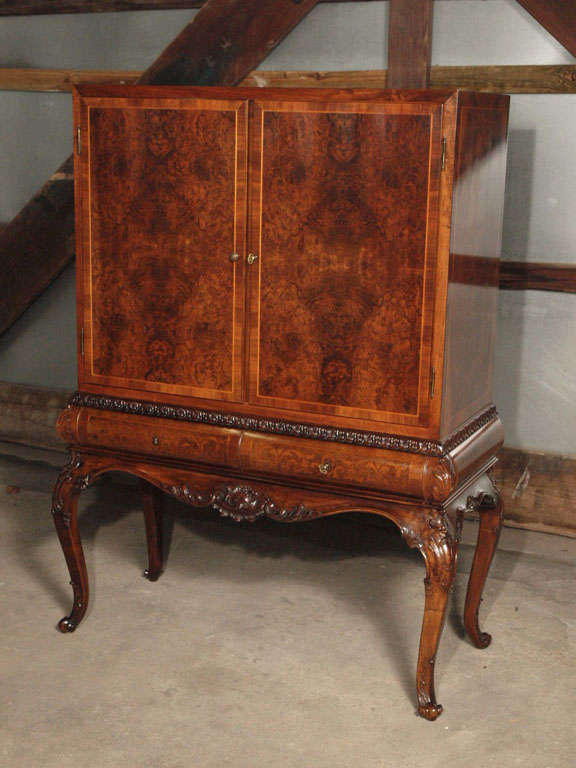 Feast your eyes on this rare and elegant Hollywood Regency Secretary. A gorgeous marriage between the art deco and Louis XV styles, this secretary is reminiscent of the glamour of the golden age of Hollywood.  Made of solid french walnut with burled