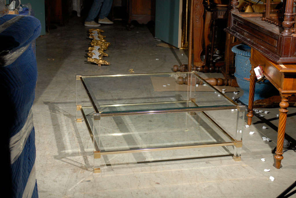 Lucite, glass and brass coffee table created in Paris by Pierre Vandel.