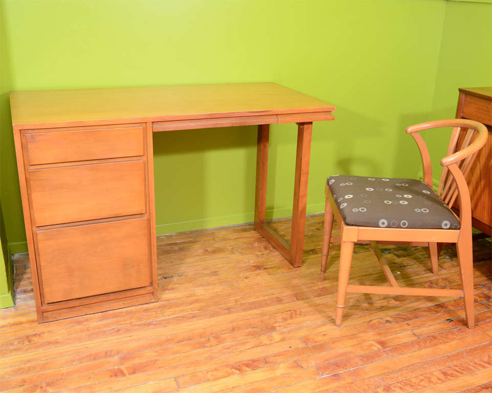A vintage writing desk and chair in maple by Russel Wright for Conant Ball. The chair is unmarked while the desk has the 