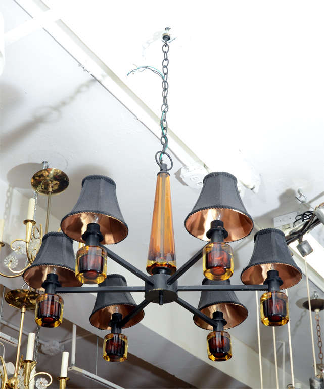 A vintage Italian chandelier in black enameled metal with amber colored Murano glass detailing.

Reduced from: $4,950