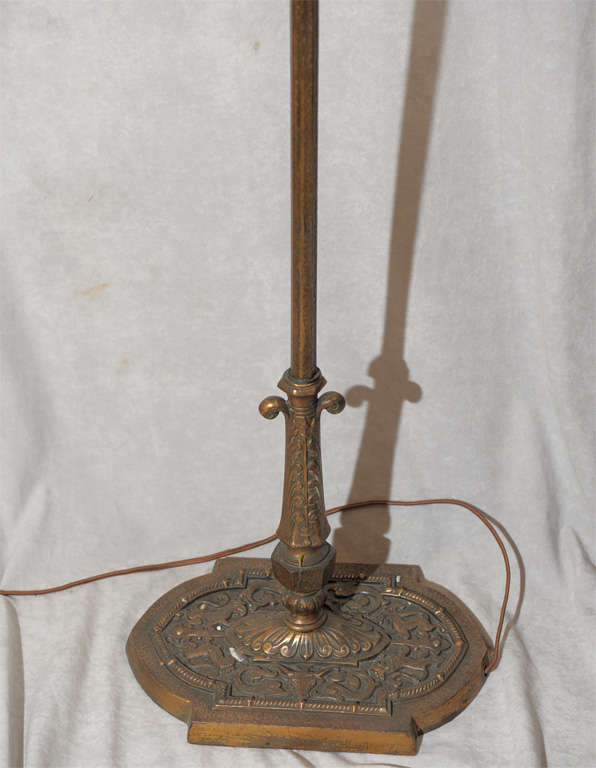 This fabulous cast bronze bridge lamp has an original metal mesh decorated shade.  This whimsical and masculine lamp has a heraldic theme with lions and knights; perfect for the man's den.  Most of these bridge lamps are cast iron; this one is