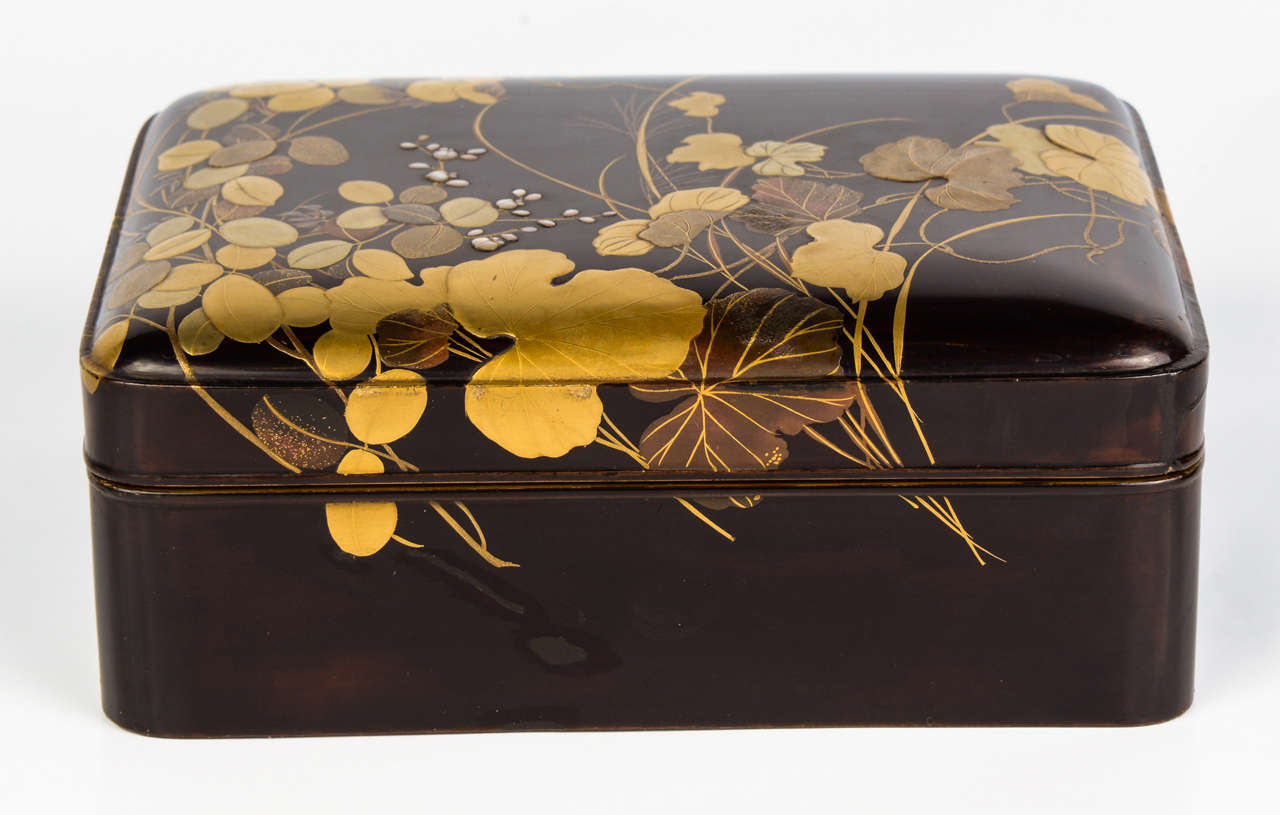 Black lacquer kobako with gold lacquer flower decor and inlays. The interior is in nashi-ji lacquer.