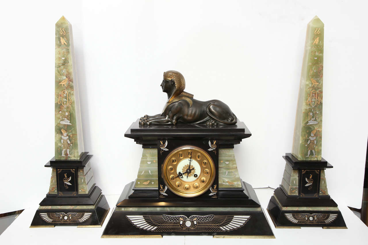 A set of very fine quality 19th century French onyx, slate and bronze three-piece Egyptian Revival clock set. The inlaid works are polychromed with silver and gold colors.
Stock number: CC62.