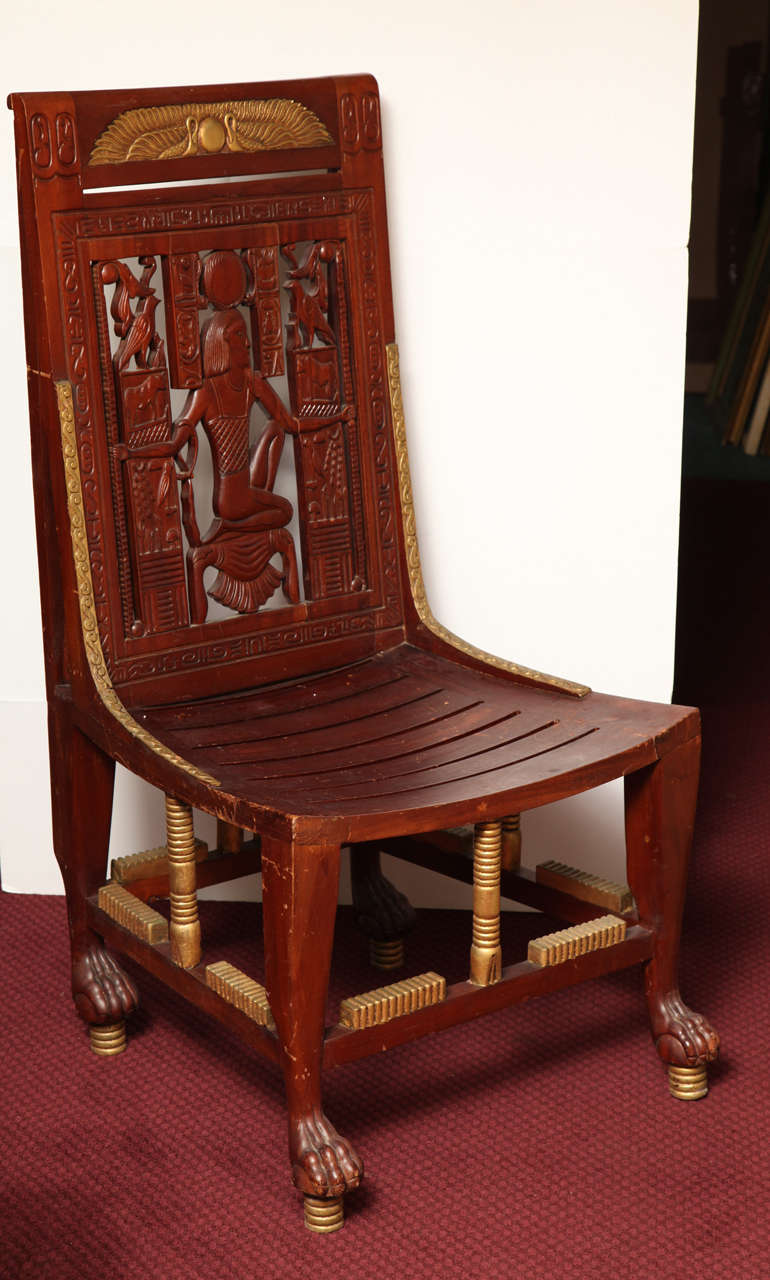 Pair of highly decorative early 20th century Egyptian Revival carved wood and parcel-gilt chairs.
Stock Number: F97