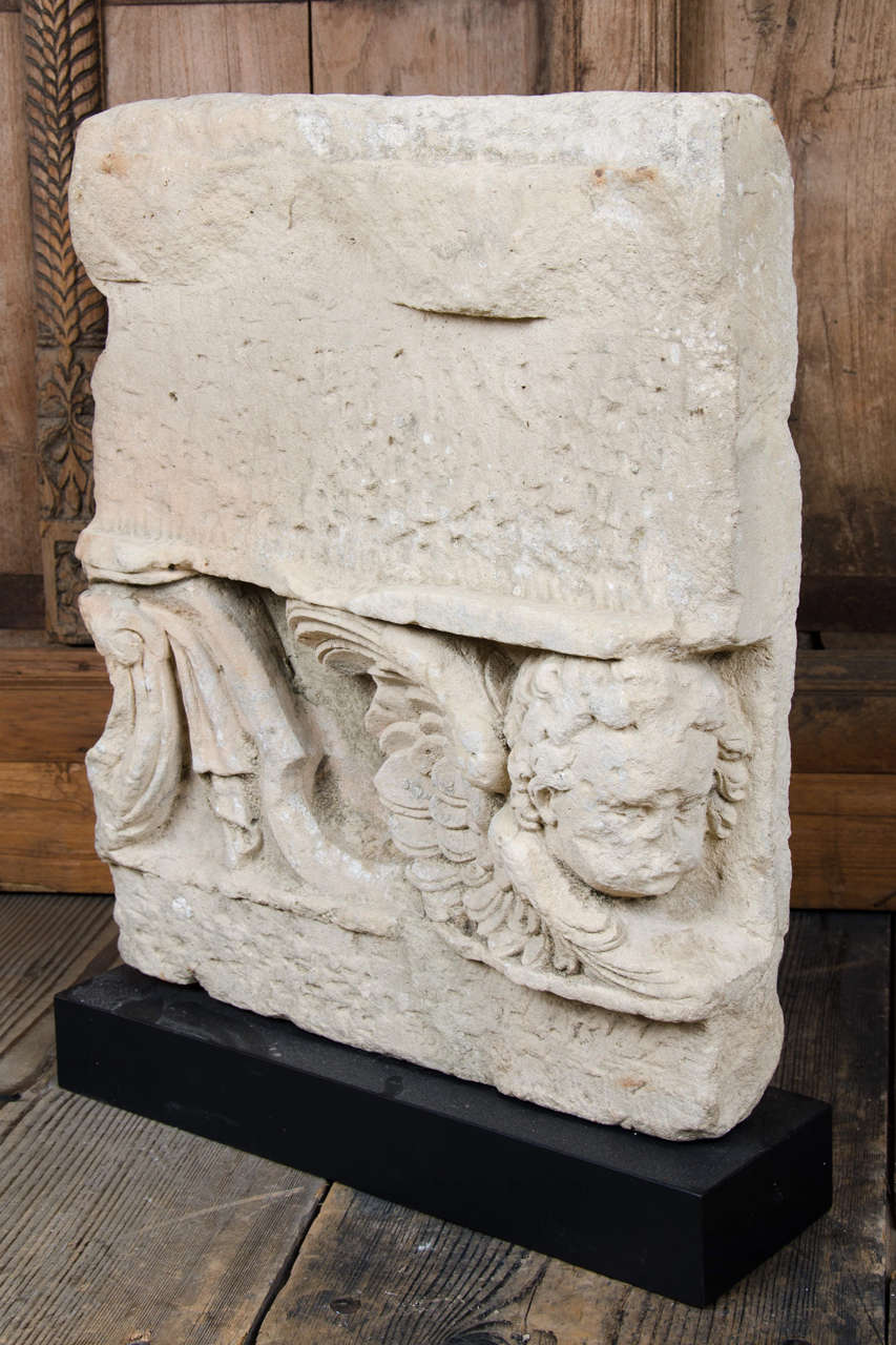A fragmentary architectural element depicting a seraph and draperies, 17th-18th century.