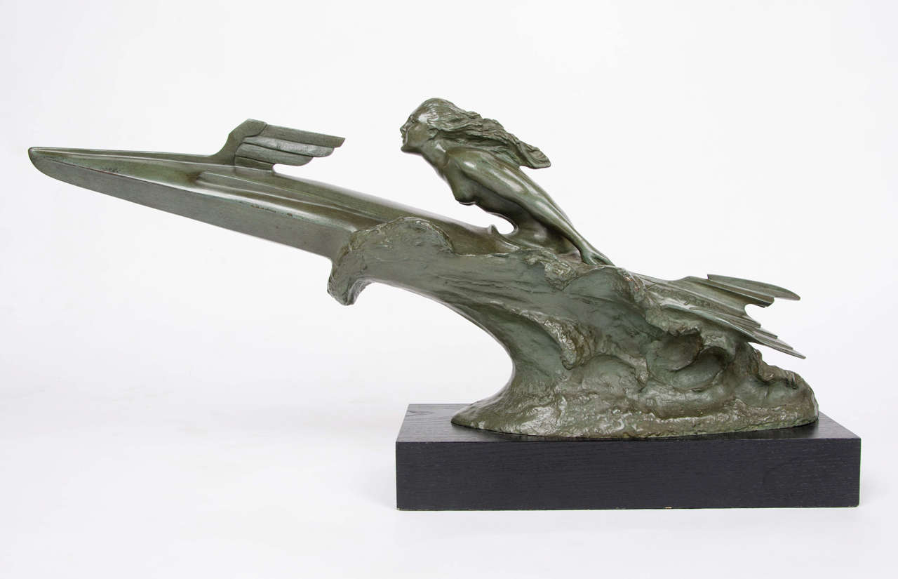 Sport-Nautique, an Art Deco bronze sculpture by Frederic Focht (1879-1937). One of only two known examples, this is a stylized bronze figure of an Art Deco nude, hair flowing, riding out of the waves on a rocket in verdigris green patination. Set on
