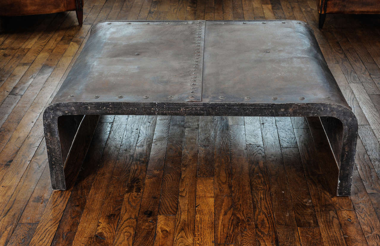 A French Industrial polished weathered riveted steel coffee or center table, made of an old water tank, Machine Age.