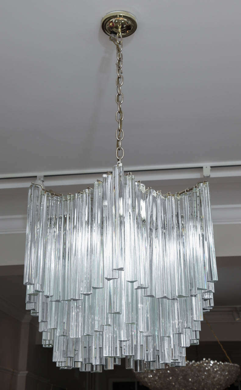 A very striking Venini crystal chandelier in an unusual hexagon-like shape. The chandelier, circa 1960s, is composed of a metal frame with hundreds of clear class triedri shaped crystals hanging from six tiers. This will truly light up a room!