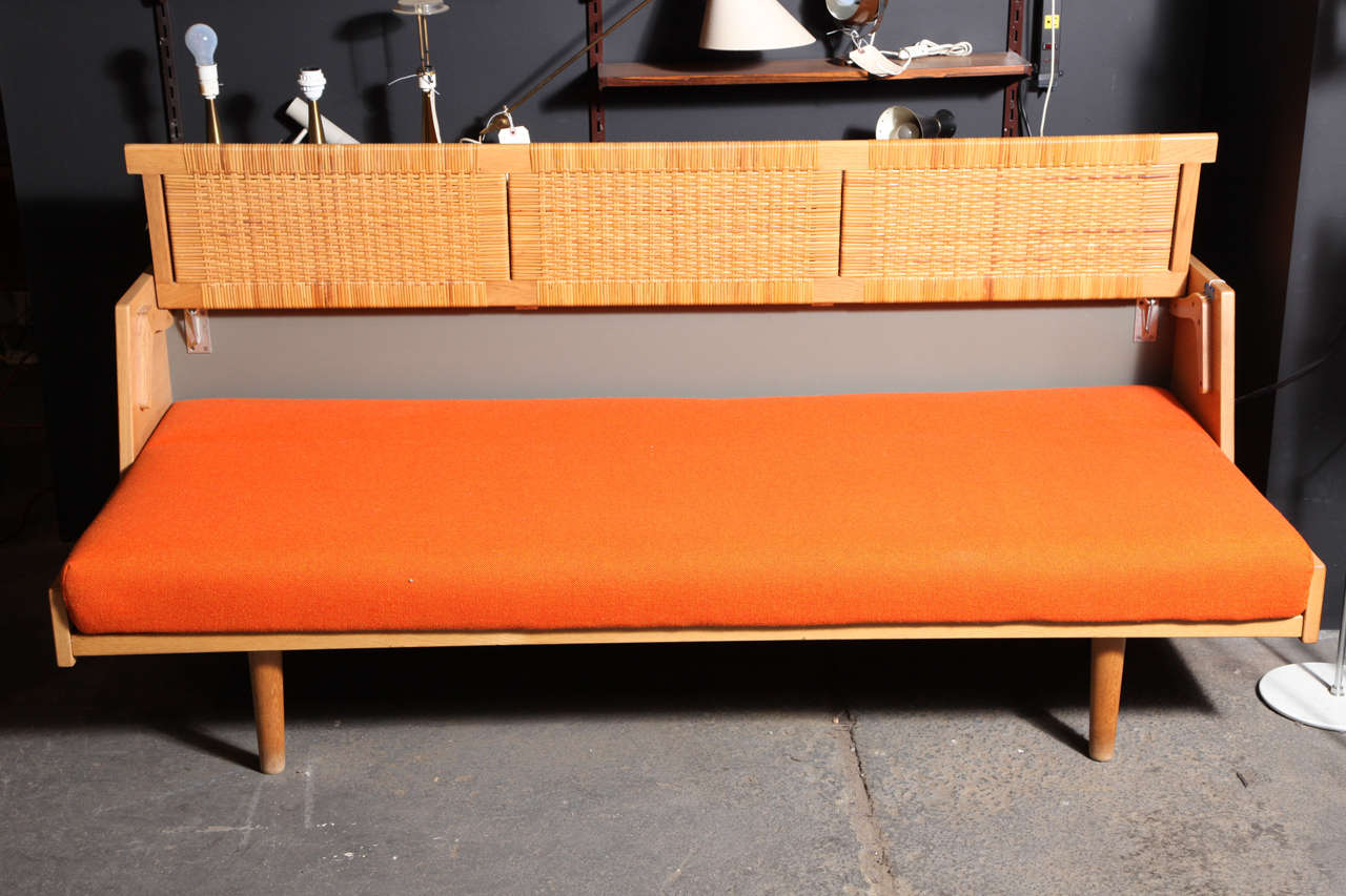 Vintage 1950s Caned Day Bed by Hans Wegner

This Vintage Day Bed in like-new condition. The back support lifts easily and securely to make room for one person to sleep on. This is a Hans Wegner classic newly upholstered in wool, or we can