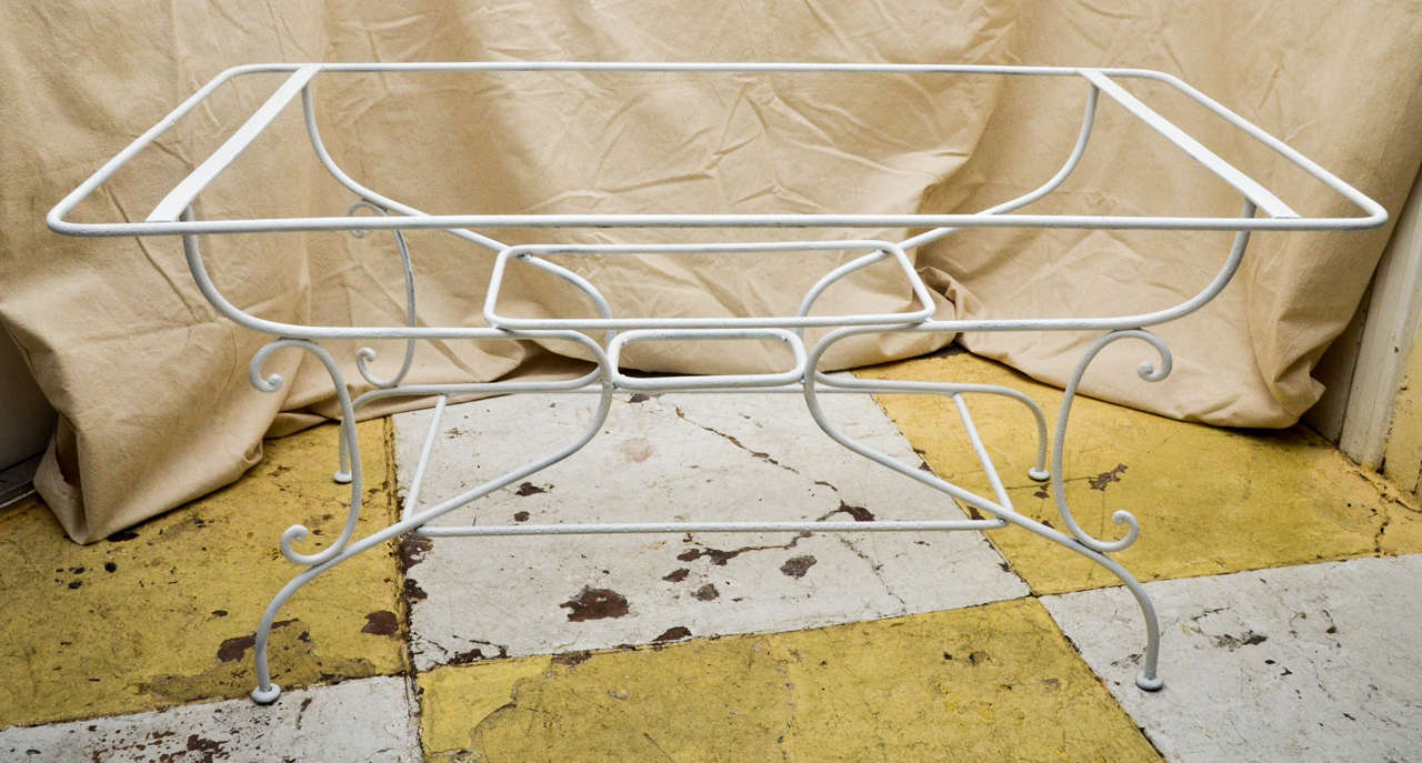 French wrought iron 19th century white painted rectangular garden table base. The frame has graceful curved legs that are supported by C curved supports and three rounded edge rectangular stretchers. Thus making a very stabile table to carry a