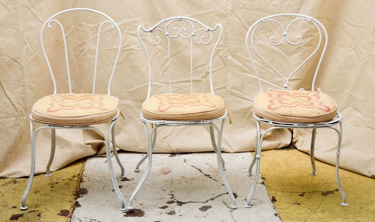 Assembled set of six French 19th century garden chairs with needlework cushions. The set consists of three pairs of the same design. The seat height and width of the chairs are the same, one pair is a inch higher. The chairs are approximately the