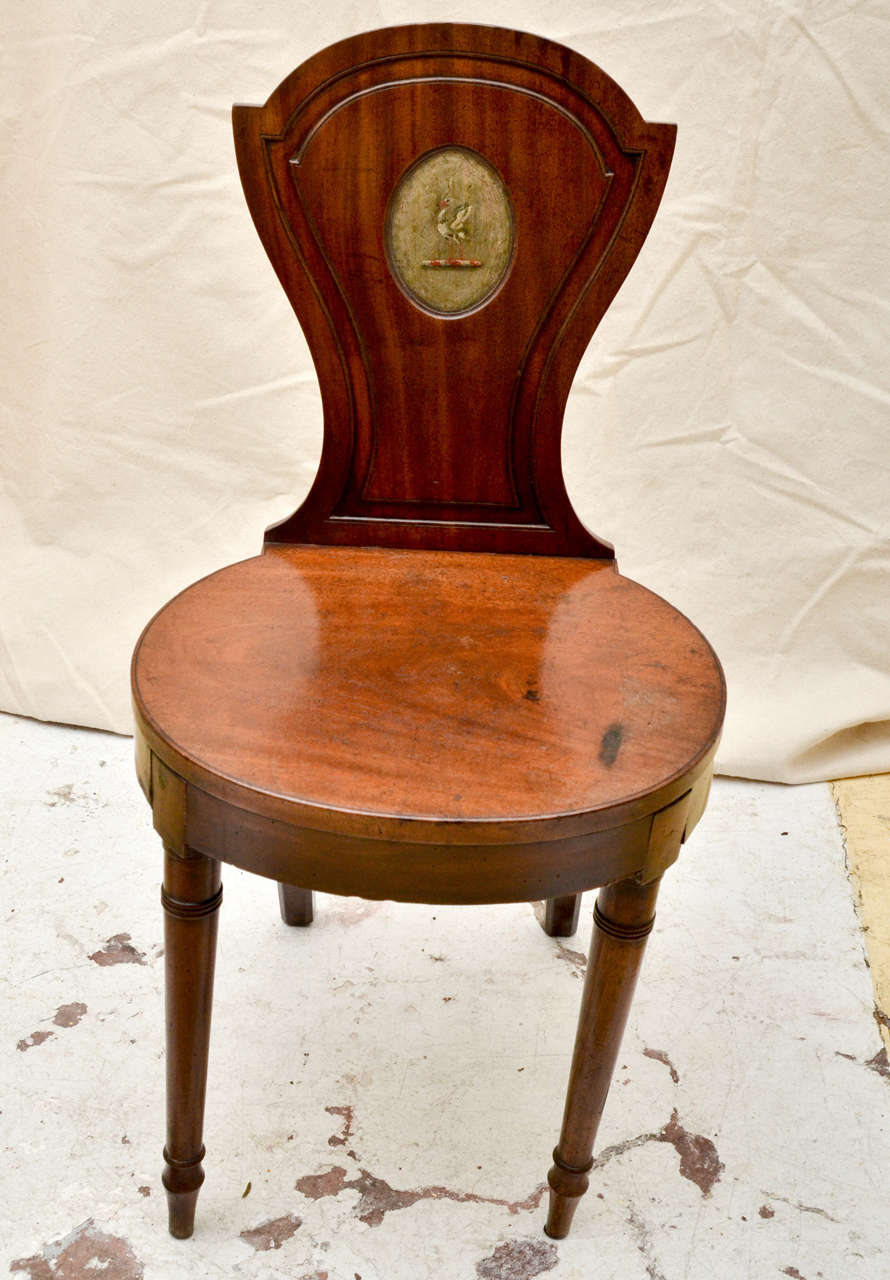 English mahogany late 18th century-early 19th century hall chair with an arched top tapered back. Having a 50