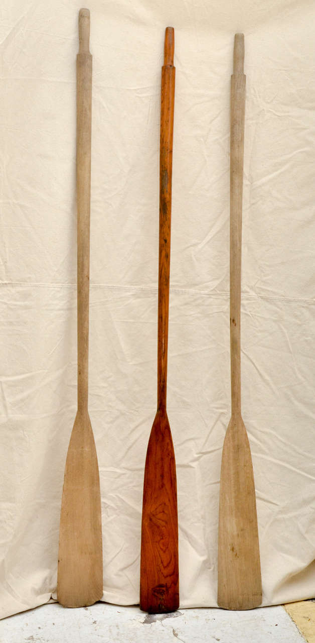 Three American oak oars. One varnished, that has a black stamp of pennant, inside circle with standard brand brand. Made in the U.S.A. Great as decoration in nautical themed room.