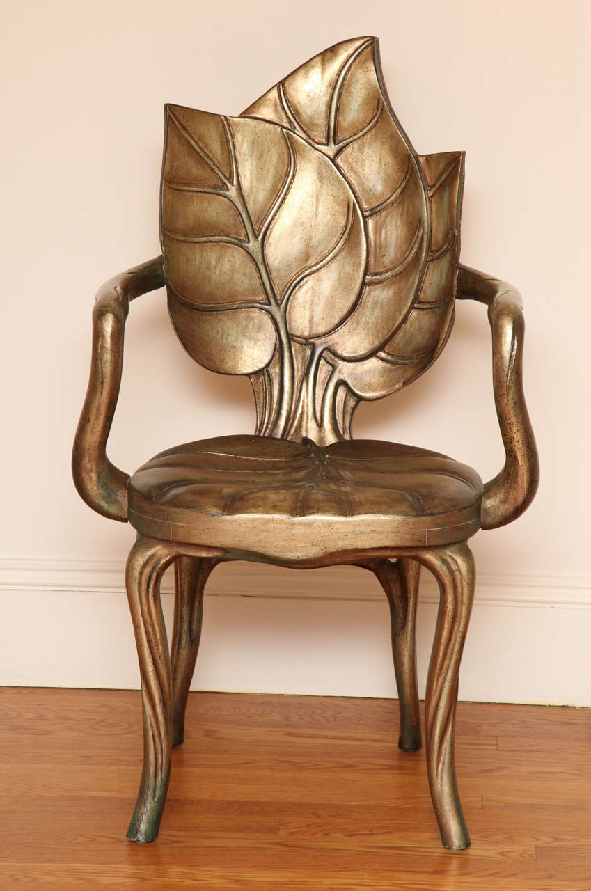 Each chair hand-carved and gilded with leaf-form back issuing branch-like armrests leading to a foliate seat, raised on branch-like downswept legs. Also available by the pair.