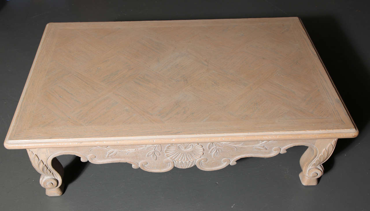 Beautifully hand-carved in the workshops of Subbachi. The whitewashed oak table with rectangular top over a deep scalloped frieze centered with shell decoration and raised on foliate-carved scroll form feet.