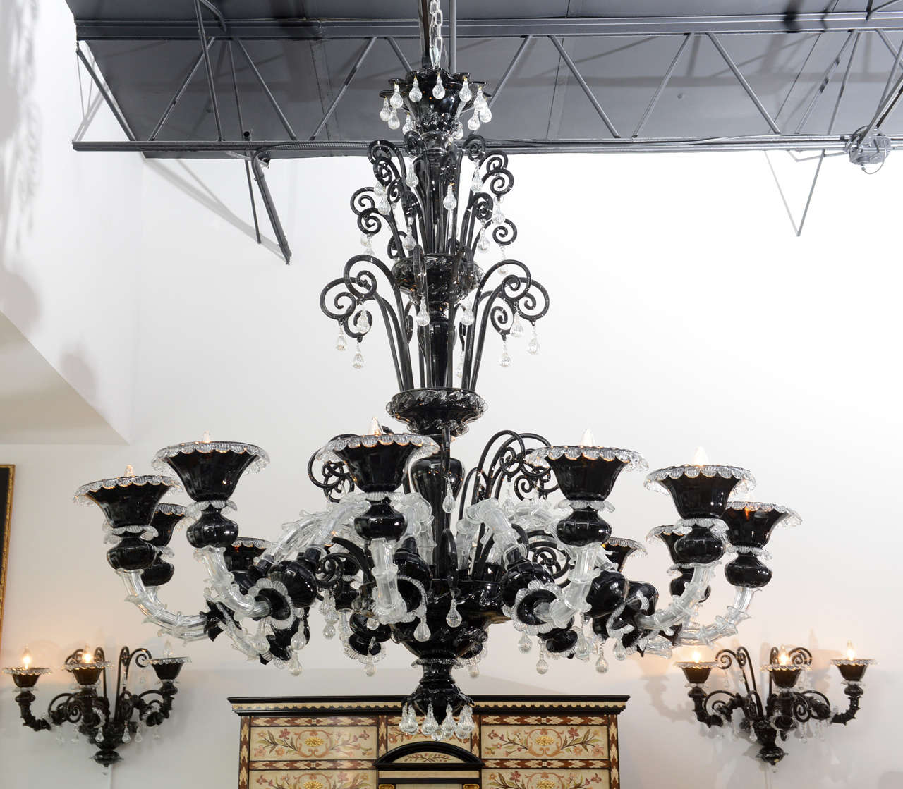 Chandelier with scrolling arms, pendants and drops.
Marked Murano.
