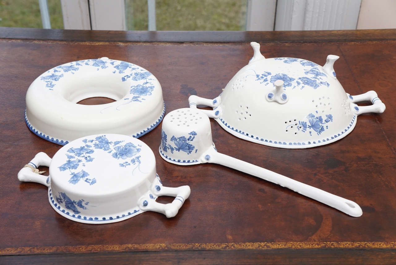 Blue and white ceramic cooking utensils including a footed sieve, ladle, ring jelly mold and a small ceramic baking dish. Can be hung on the wall. Measurements are for the sieve.