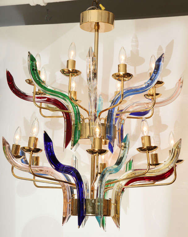 A vintage chandelier in the style of Venini, the brass two tier frame comprised of sixteen arms alternating with 16  multi-colored thick  