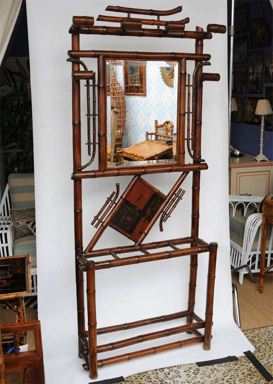 Late 19th century English bamboo hall tree and umbrella stand with central beveled glass mirror surmounting a lacquer decorated panel.
already reduced from $2550.