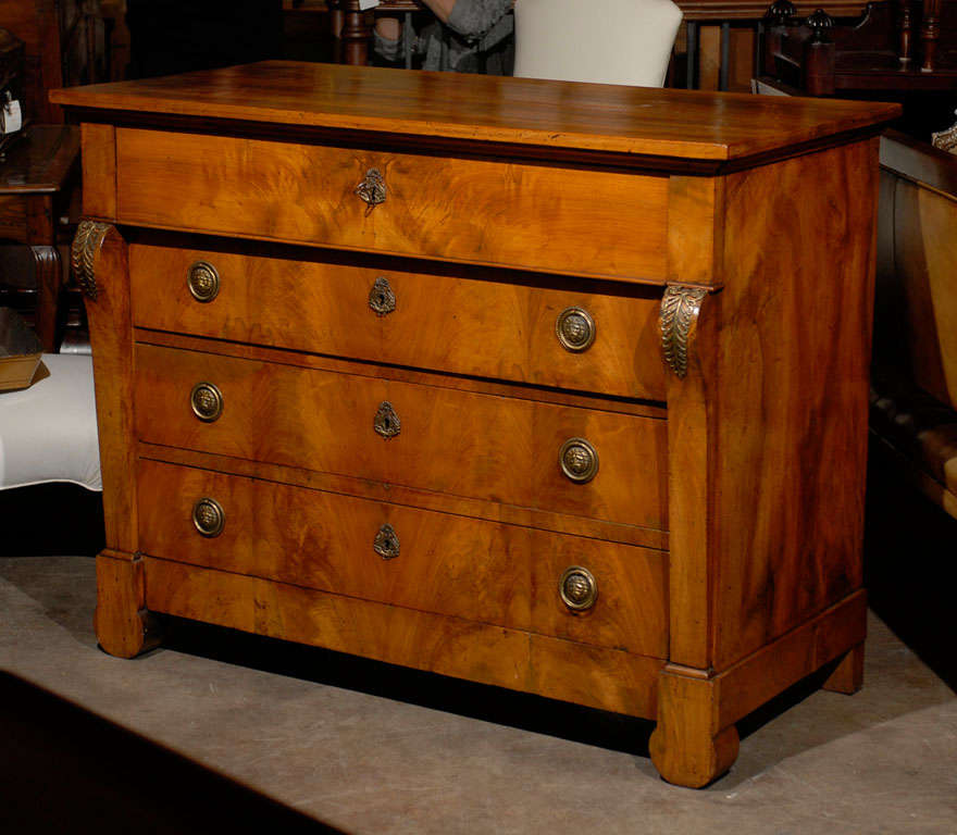 French Empire walnut chest with pullout desk. A leather panel exists in the desk and two secret pullout drawers. The chest has two bronze mounts on the front. Lion head pulls may not be original.